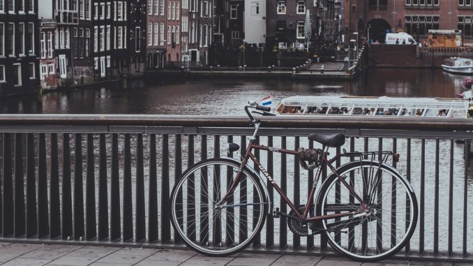 When I arrived in Amsterdam I grabbed my camera and threw it over my shoulder and went out to explore by bike. after about a hour of riding and taking pictures I stopped at this bridge to look around and the bike leaning on the bridge railed seemed iconic in its summation of the Dutch lifestyle. by rafaellodos (Unsplash.com)